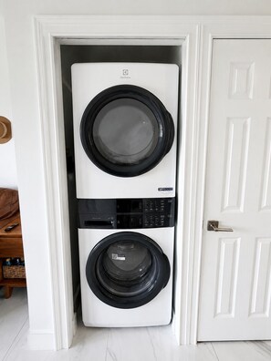 A compact, wall-mounted washing machine with a control panel, located in a narrow doorway. - Waterfront Villa in Duck Key | Sunset Views | Sleeps 6 (Duck Key)