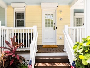 A front porch with a white door, a welcome mat, and a mailbox. - Waterfront Villa in Duck Key | Sunset Views | Sleeps 6 (Duck Key)