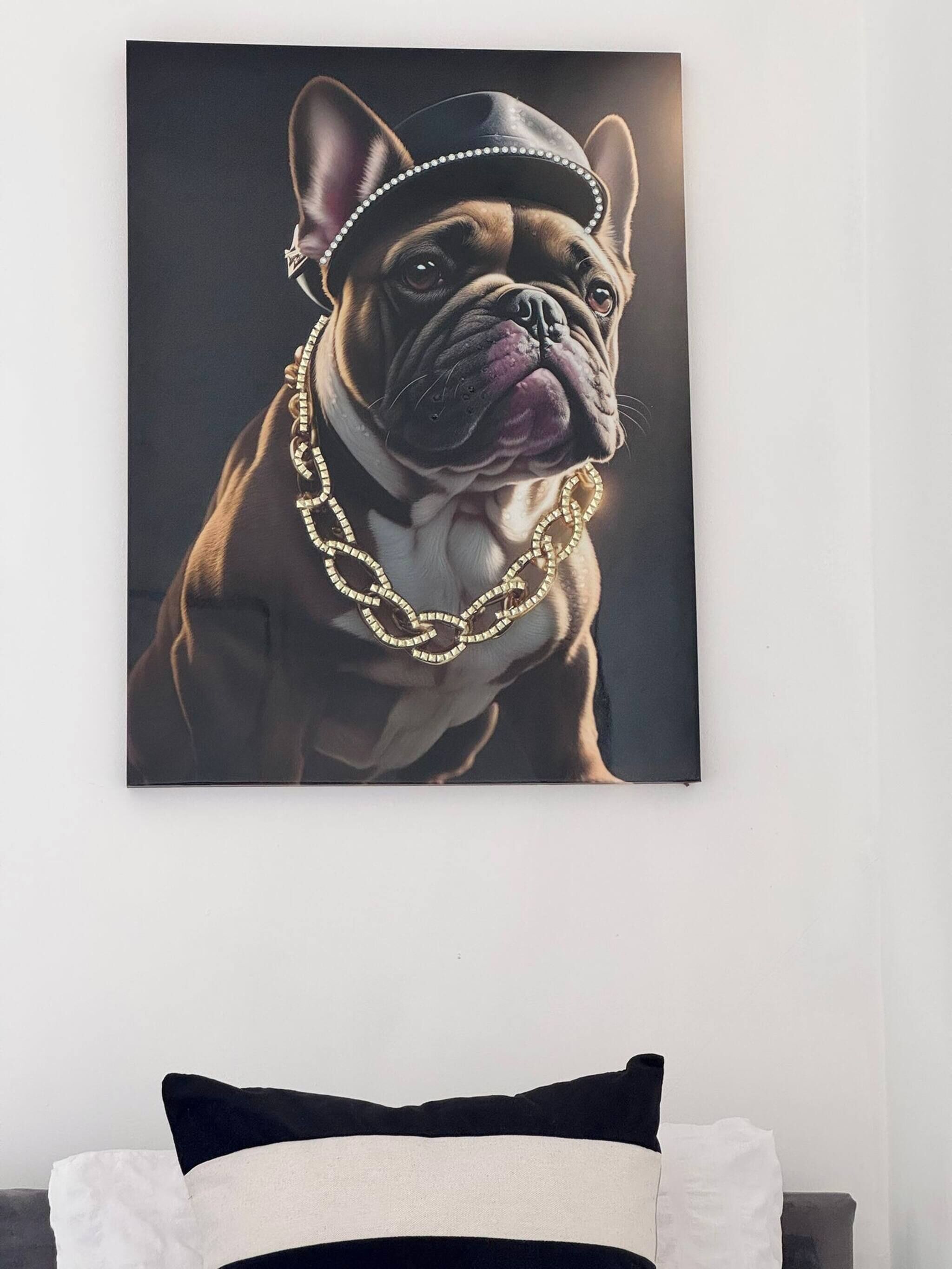 A framed artwork of a dog on a bed.