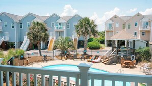 A residential area with a swimming pool, multiple houses, and a gazebo. - High Tides & Pink Skies-3BR, Pool, Views, Linens, Steps to Beach - North Topsail (North Topsail Beach)