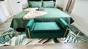 A neatly arranged bedroom with a bed, nightstand, and a green upholstered chair. - 3BR Hollywood Home nr Hard Rock, Beach & FLL (Hollywood)