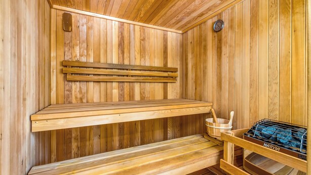 A wooden sauna with benches and a Harvia sauna heater. - Coastal Sanctuary: Newly Remodeled, Unrivaled Views, Sauna, and Steps to Ferry! (Sausalito)