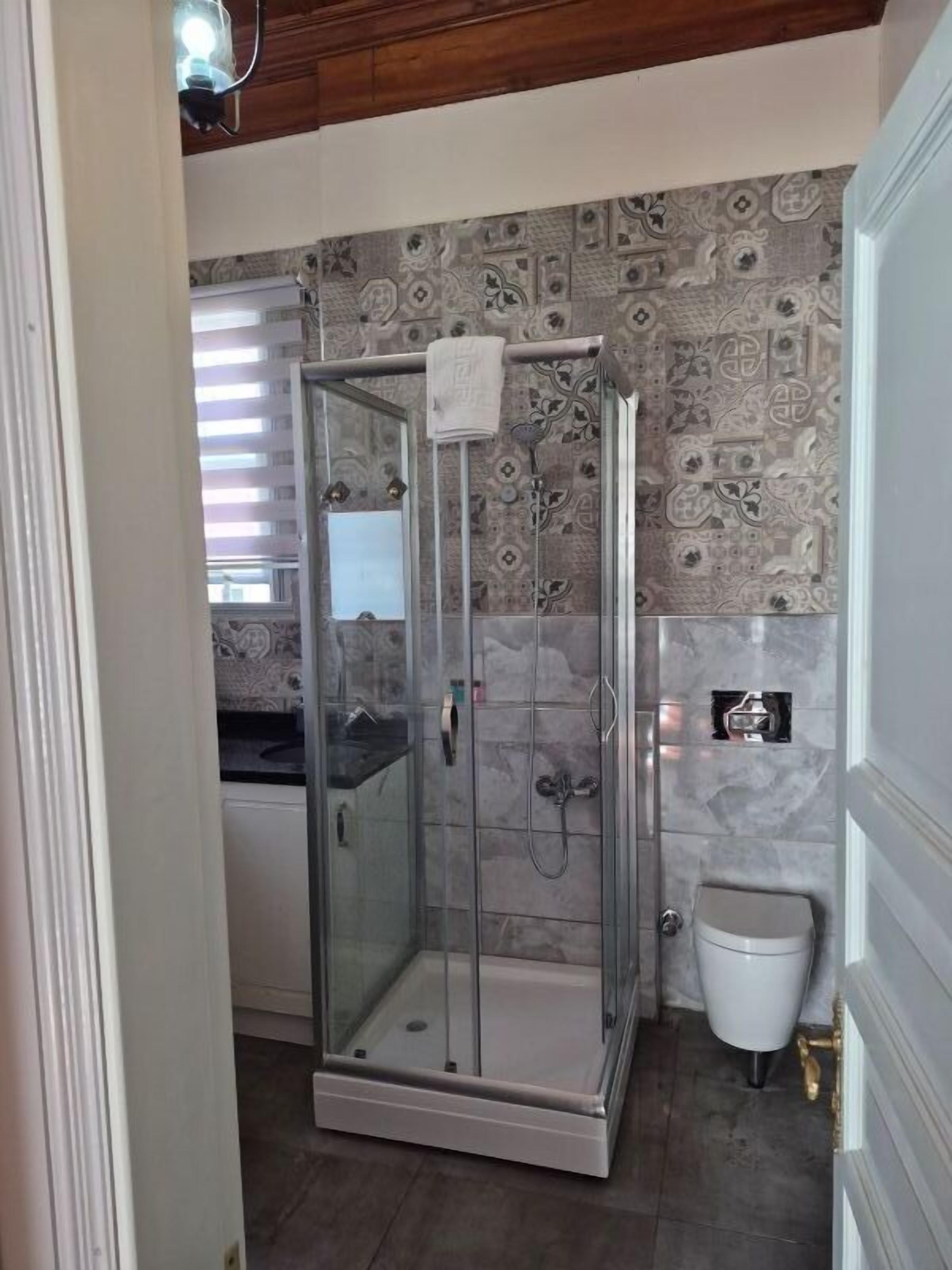 Shower, hair dryer, slippers, towels