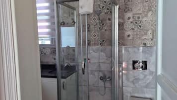 Shower, hair dryer, slippers, towels
