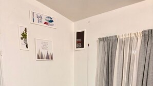 Una habitación con mesa de fútbol, ventana con cortinas y adornos en la pared.