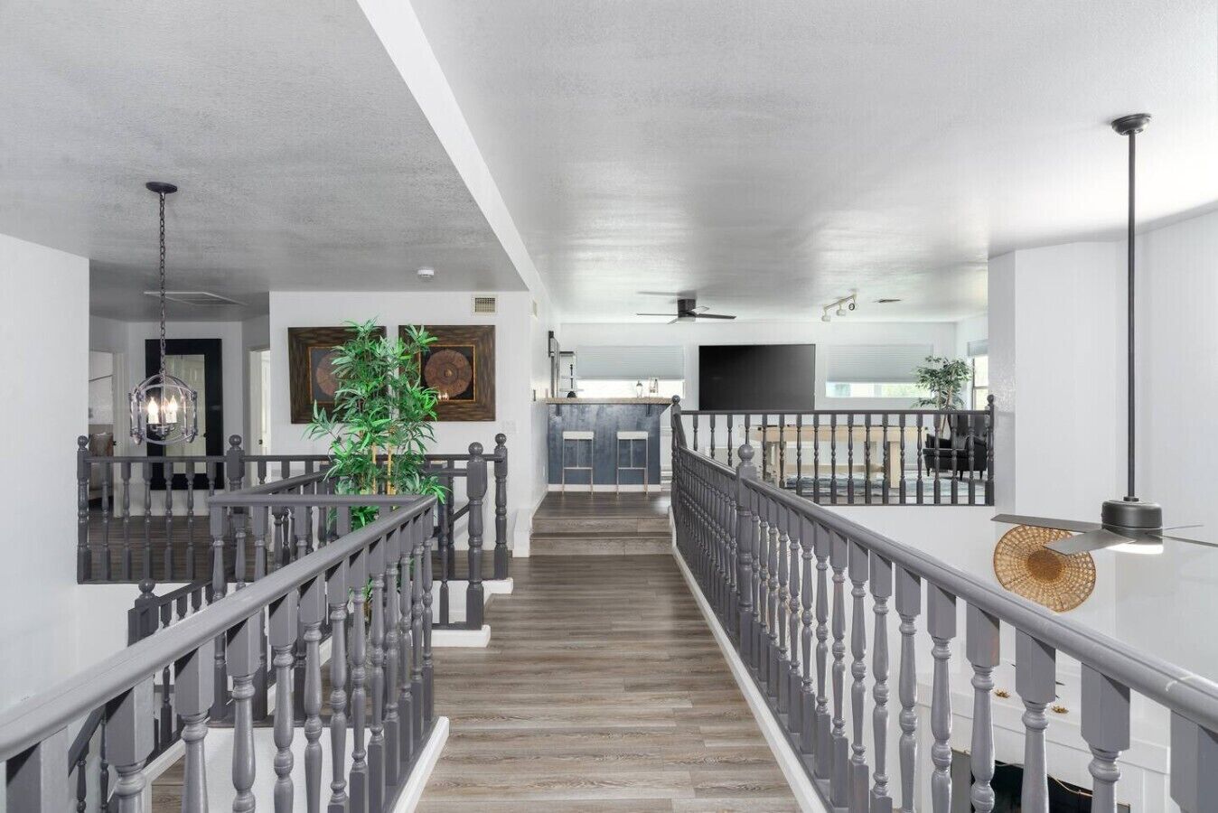 A spacious interior with a central staircase, a dining area, and a kitchen.
