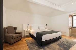 A bedroom with a bed, a chair, a nightstand, and a window. - Serene Countryside Parada de Tibães Location | Easy Access to Local Attractions (Braga)