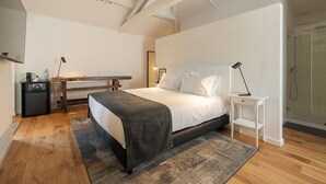 A modern bedroom with a bed, bedside table, and a desk with a chair. - Chic Rural Escape with Pool Access and Relaxing Ambience in Parada de Tibães (Braga)