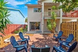 A two-story building with a deck, outdoor seating, and a fenced backyard. - 217 Cherie Down Ln (Cape Canaveral)