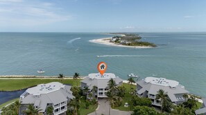 A coastal property with multiple buildings, a marina, and a beach. - 1617 Lands End Village | Best View on Captiva! (Captiva)