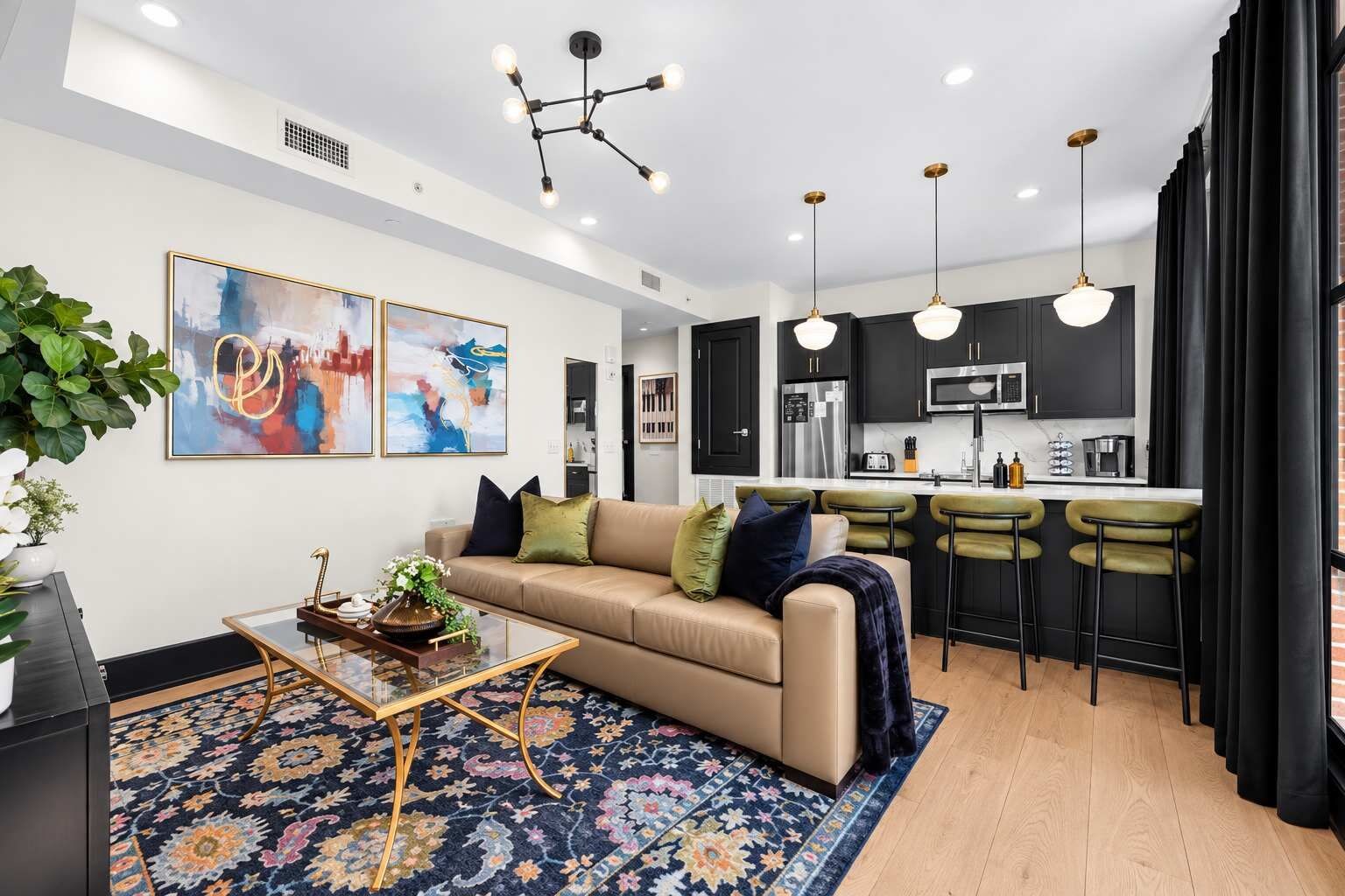 A modern living room with a sofa, coffee table, and artwork on the wall.
