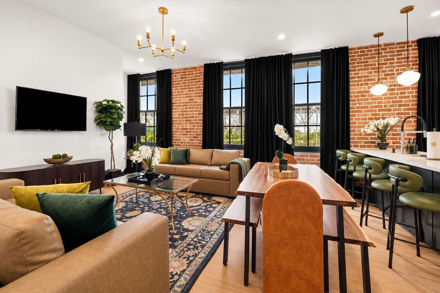 A modern living room with a sofa, coffee table, and dining area with chairs.