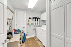 A laundry room with a washing machine, a dryer, and a water filtration system. - Dunes of Crystal Beach 404 - Beachfront Condo with Community Pool in Destin (Destin)