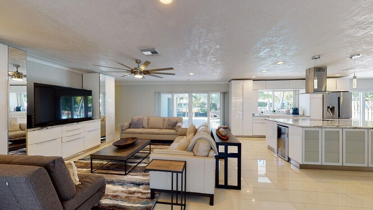 A spacious living area with a sofa, coffee table, and a TV.