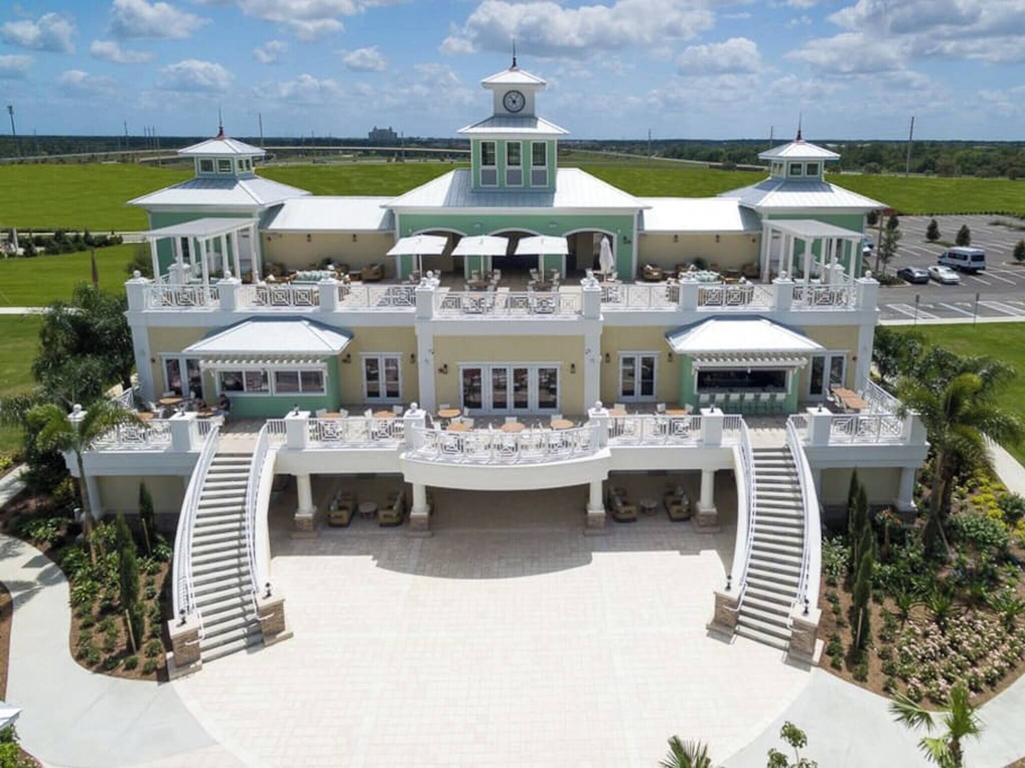 A large, multi-story hotel with a central courtyard, multiple balconies, and a symmetrical facade.