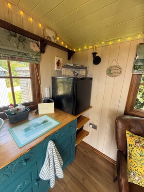 A kitchen with a black refrigerator, a wooden countertop, and a window with curtains. - Where luxury meets farm life in rural Wales yet close to amenitie. (Monmouth)