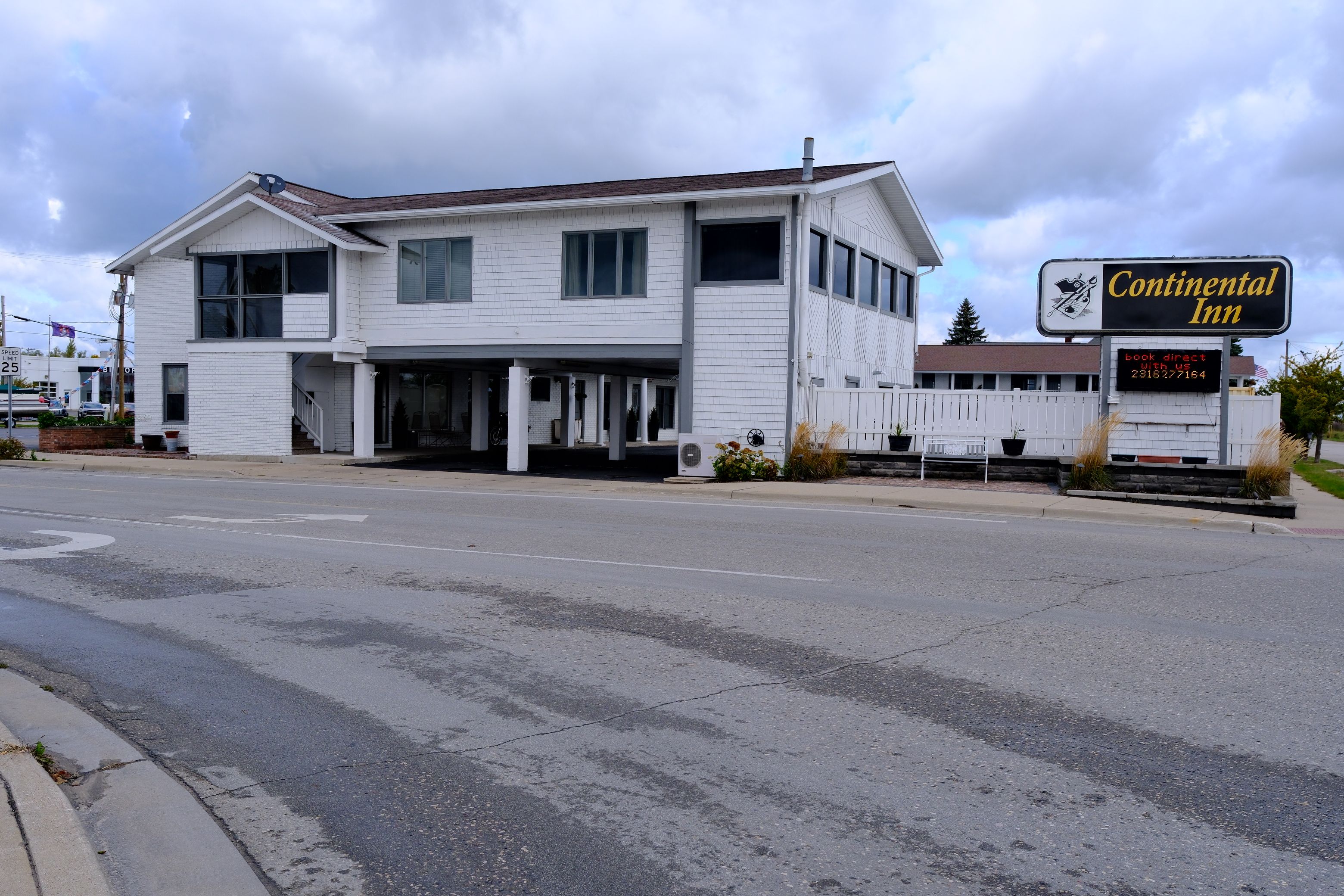 A two-story building with a sign for Continental Inn.