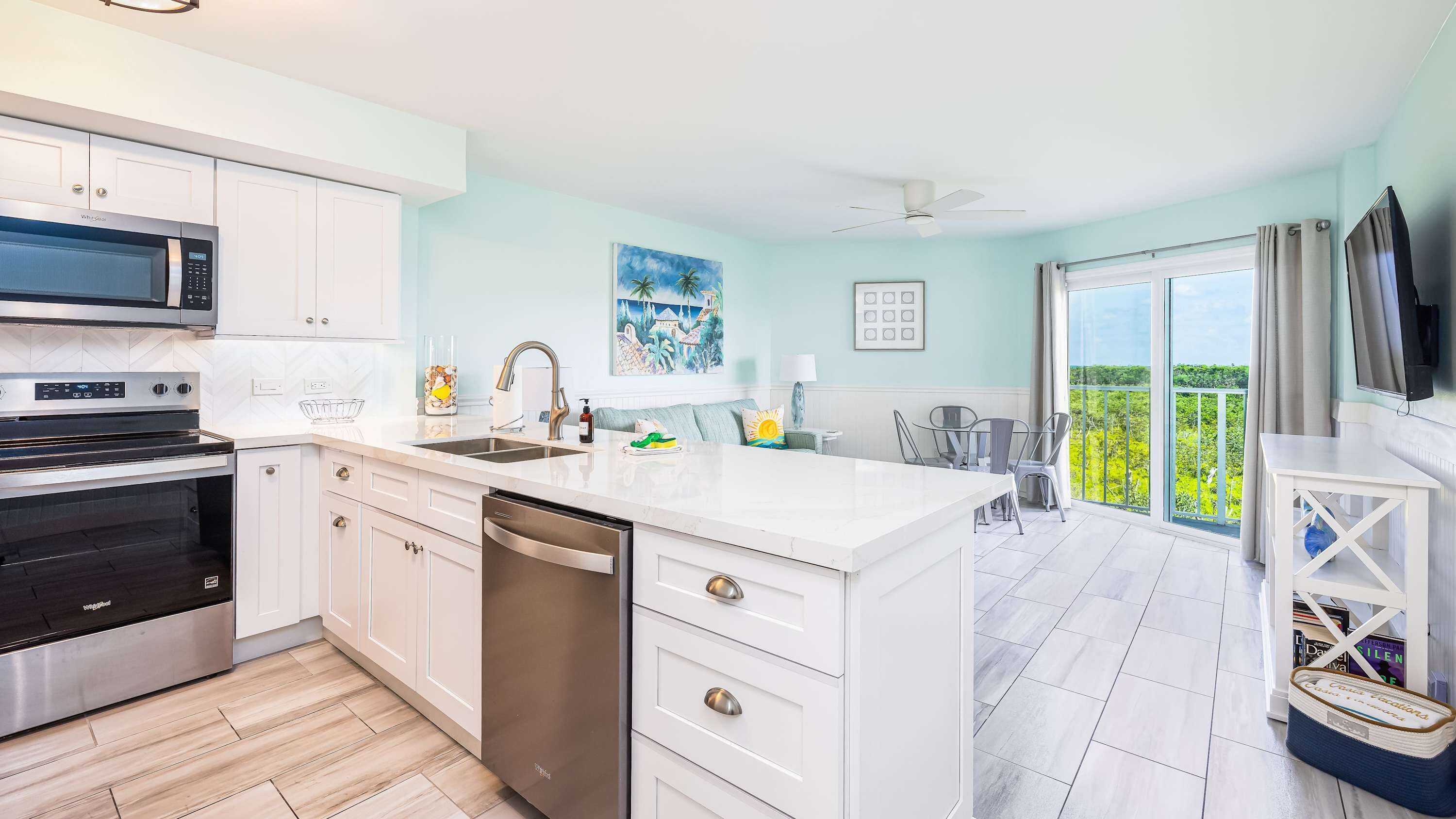 A modern kitchen with white cabinetry, a built-in oven, and a dishwasher.