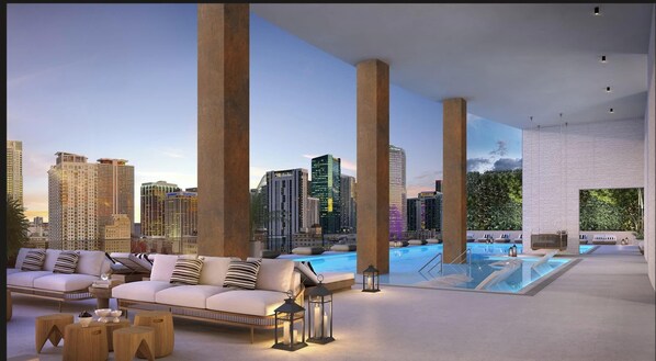 A rooftop lounge with a city view, a pool, and modern furnishings. - City Dreams Sauna, Rooftop Pool & Parking (Miami)