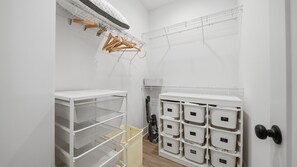 A storage closet with shelves, baskets, and labeled storage bins. - Elegant 3BR Retreat  close to Hospital & Downtown (East Ridge)