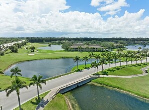 A golf course with multiple ponds, palm trees, and a bridge. - 2820 Corey Road (Malabar)