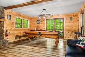 A wooden interior with a pool table, stone wall, and a fire extinguisher. - 5 Mins to Pigeon Forge! Hot Tub*Game Room*Fire Pit (Pigeon Forge)