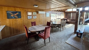 A wooden interior with a dining table, chairs, and a sofa. - Mountain Chalet next to Angeles National Forrest and near Hard Rock Casino Tejon (Frazier Park)