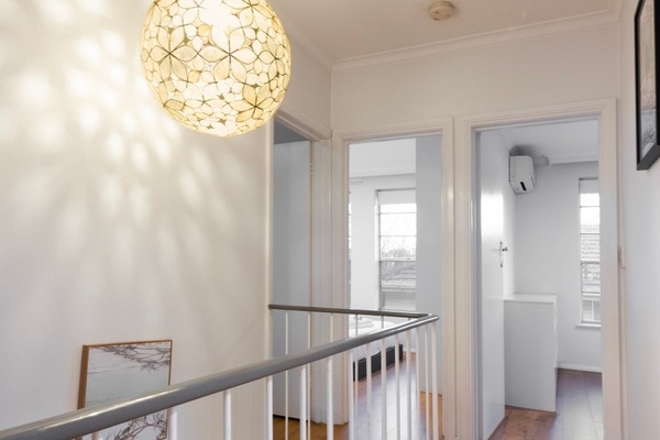 An airy landing enhances the home's spacious and open design.