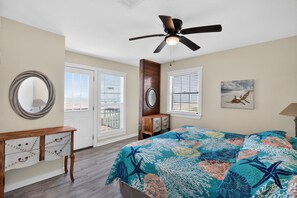 A bedroom with a bed, a ceiling fan, a dresser, a mirror, and a window with blinds. - BEACHFRONT! FIRST ROW! Stunning ocean views from two levels of decks. (Surfside Beach)