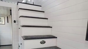 A staircase with a handrail and a sign that says 'Please' on the wall. - Cozy 1-bedroom tiny house in beautiful Parkersburg,WV (Parkersburg)