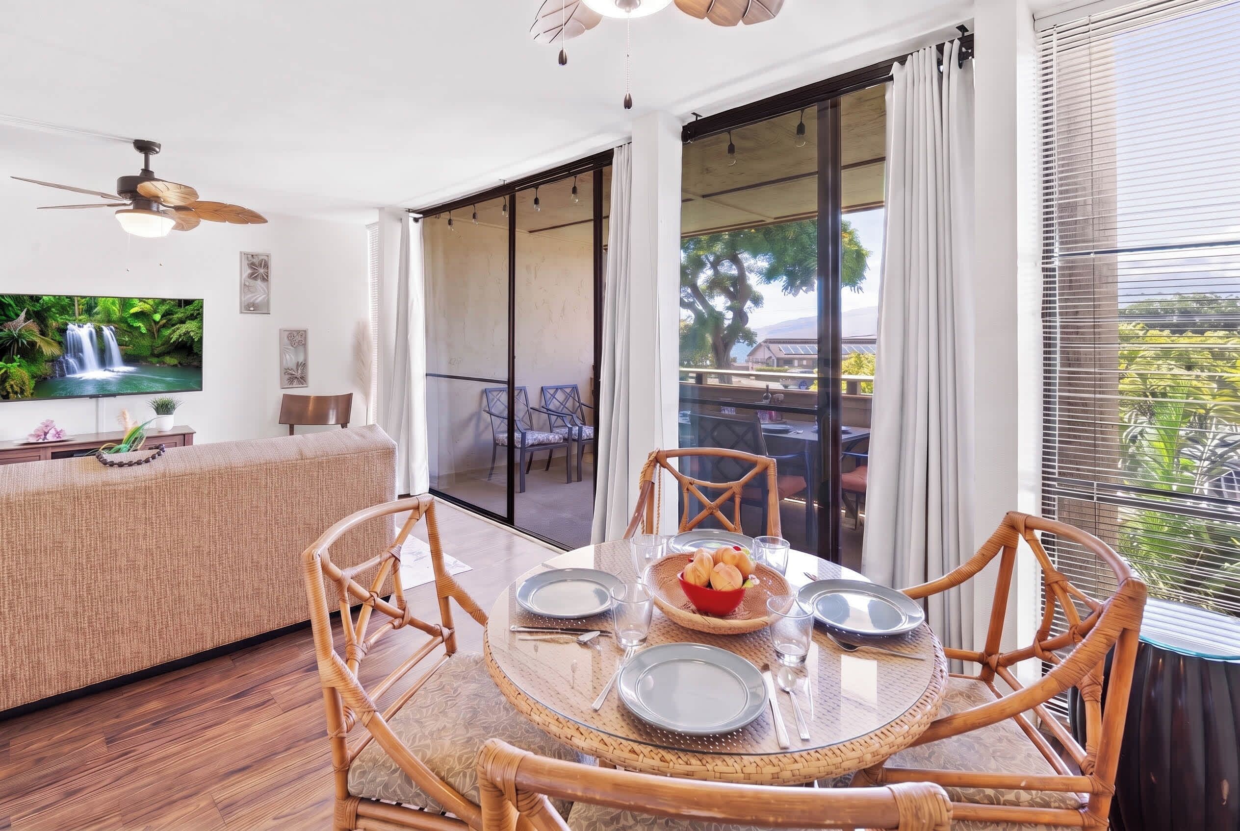 A dining area with a round table, chairs, and a view of the outdoors.