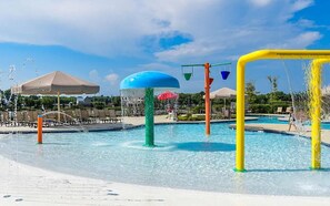 A water park with a large pool, water play structures, and lounge chairs. - Coastal Retreat w/Resort Pools & Shuttle to Beach (Millville)