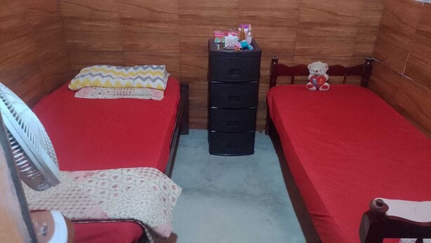 A small room with two beds, a dresser, a chair, and a fan. - Rustic house with all the charm of the coast. (Maraú)