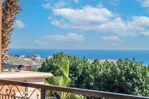 A balcony with a view of the sea and buildings. - CCV Quivira - Amazing 2BR Copala Condo w/ Ocean Views (Cabo San Lucas)