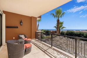 A balcony with wicker furniture and a view of the sea. - CCV Quivira - Amazing 2BR Copala Condo w/ Ocean Views (Cabo San Lucas)