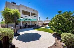 A two-story building with a patio area, outdoor seating, and a swimming pool. - Spacious 5-bedroom house in serene Lake Havasu with pool, and Lake view (Lake Havasu City)