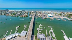 An aerial view of a coastal marina with multiple docks, boats, and buildings. - Beachfront Escape with Pool & Island Fun Steps from the Sand - Sand Caper 509 - Roelens (Fort Myers Beach)