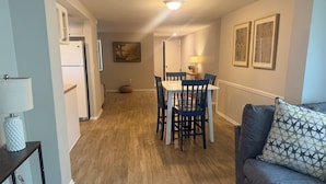 A modern kitchen with a dining area, a sofa, and a lamp. - New Port Richey Retreat- Sleeps 4 (New Port Richey)