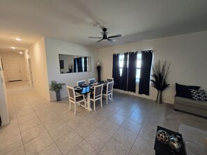A dining area with a table, chairs, and a ceiling fan. - Spacious 4-bedroom Maricopa Retreat (Maricopa)