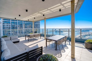 A spacious balcony with a view of a cityscape and water. - Cielo | Downtown Miami Condo,33 FL,  Rooftop Pool, Gym (Miami)