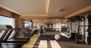 A gym with treadmills, elliptical machines, and weightlifting equipment. - Inna Resort & Spa (Puerto Morelos)