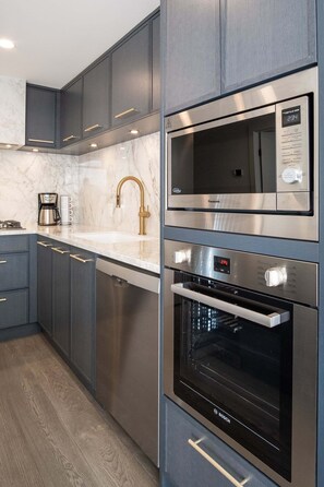 A kitchen with a microwave, oven, and coffee maker. - The Aqua Collection - Lakeview Terrace - 902 (Kelowna)