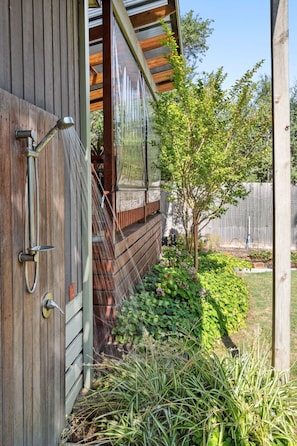 A wooden house with a wooden door, a window, and a small tree in the yard. - Beachside Nostalgia | Family Holiday Home on Dare Street, Pet friendly, Walk to the beach (Ocean Grove)