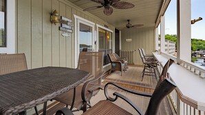 A covered outdoor area with a table and chairs, a ceiling fan, and a view of a body of water. - Starfish Haven|Lake View|Pool| Boat Ramp| Sleeps6 (Lake Ozark)