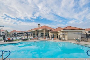 A swimming pool with lounge chairs and umbrellas, surrounded by buildings with red-tiled roofs. - N Scottsdale Oasis Pool Balcony Parking WD WiFi (Scottsdale)