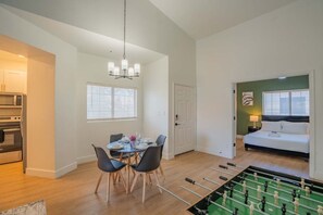 A compact living space with a dining area, kitchenette, and a bedroom with a bed and nightstand. - N Scottsdale Oasis Pool Balcony Parking WD WiFi (Scottsdale)