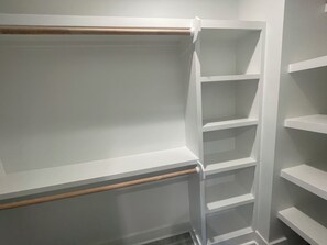 A corner of a room with white walls and a wooden floor. There are white shelves with no items on them. - On the Intracoastal Waterway with a dock. Bring your boat, minutes to the beach (Oak Island)