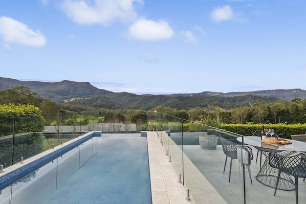 An infinity pool with a clear view of the surrounding landscape.