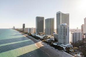 A coastal cityscape with high-rise buildings, a beach, and a clear sky. - Oceanfront Penthouse with Pool and Beach Access (Hollywood)