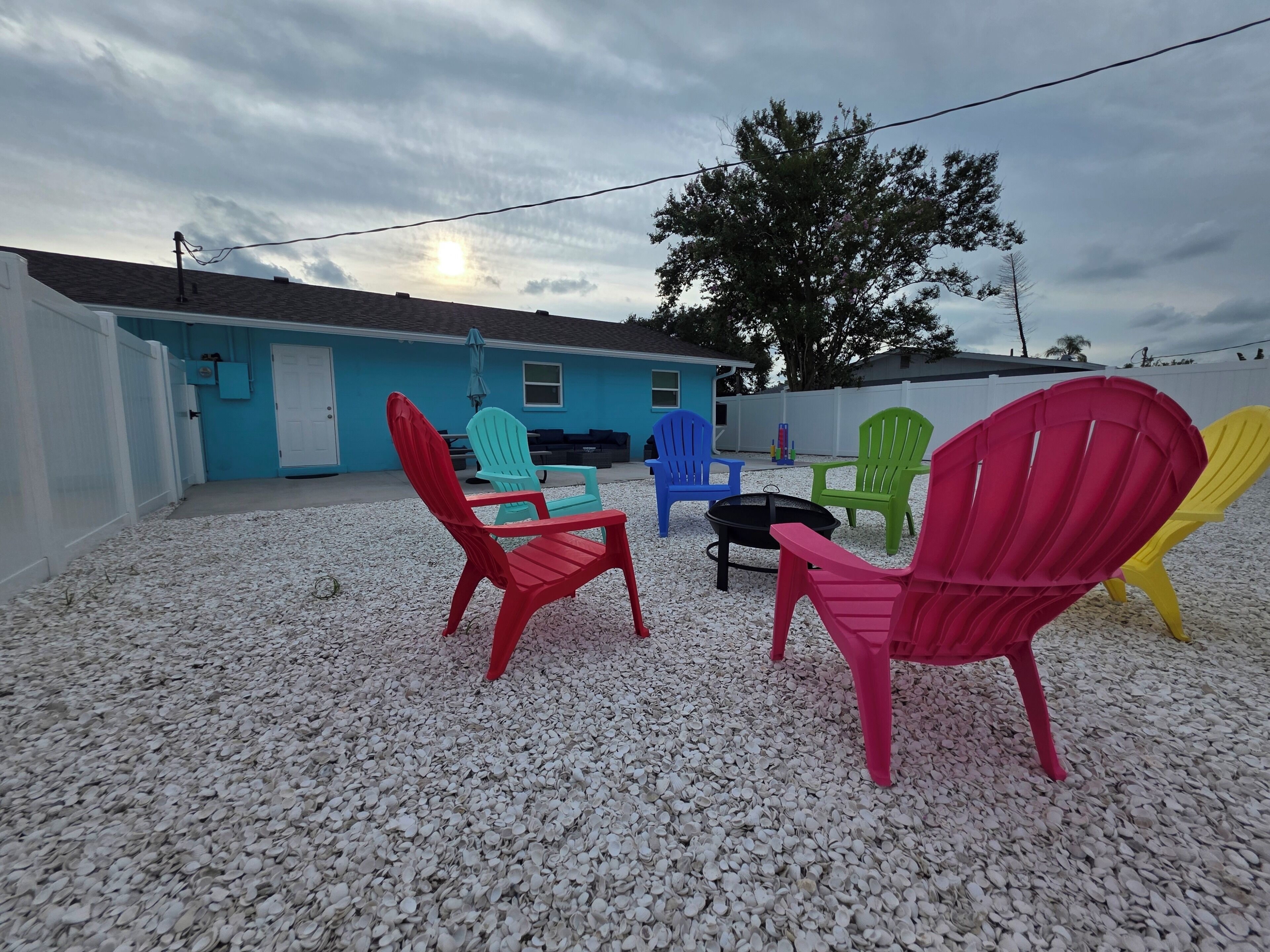 A patio area with outdoor furniture and a house in the background.